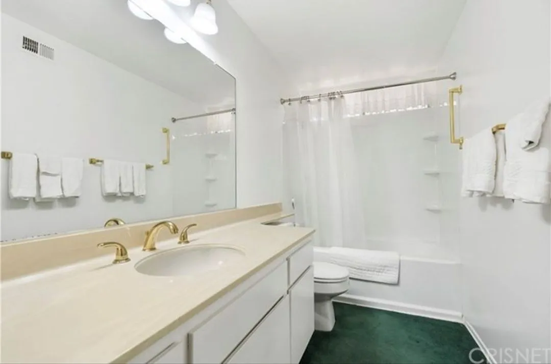 Outdated bathroom with old fixtures and green carpet before renovation