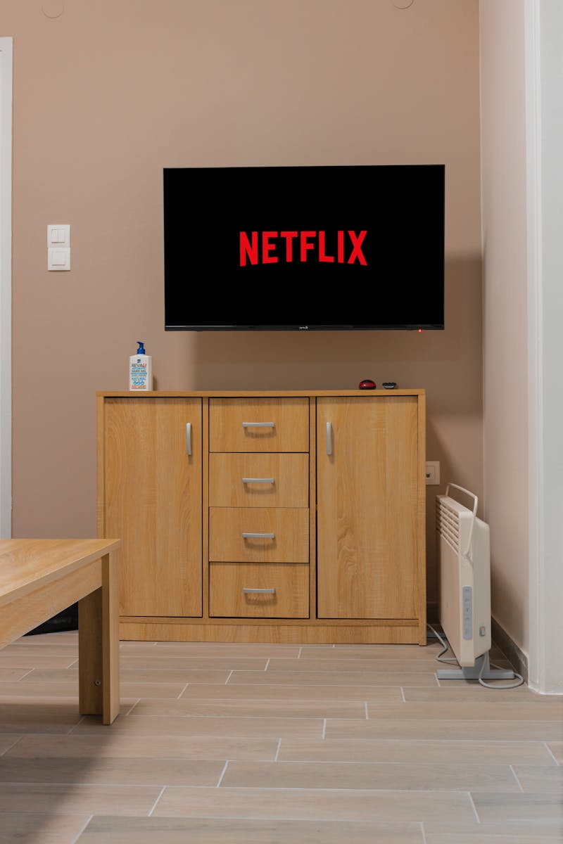 TV wall mounted above cabinet with clean cable management