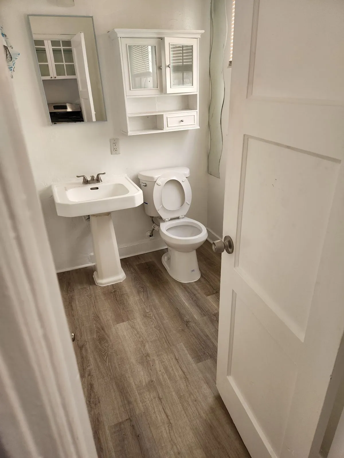 Small bathroom with pedestal sink and new flooring