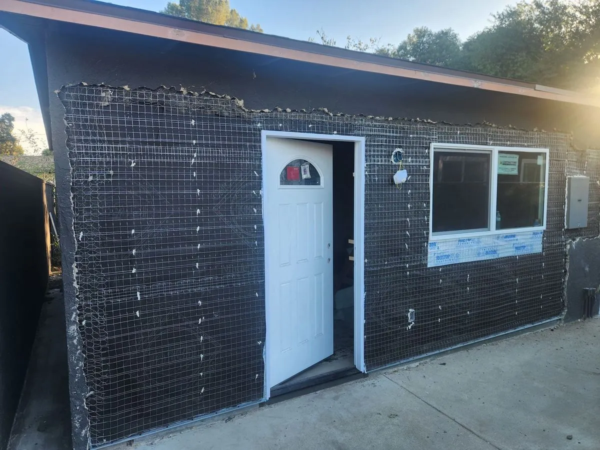 Exterior wall stucco preparation with wire mesh