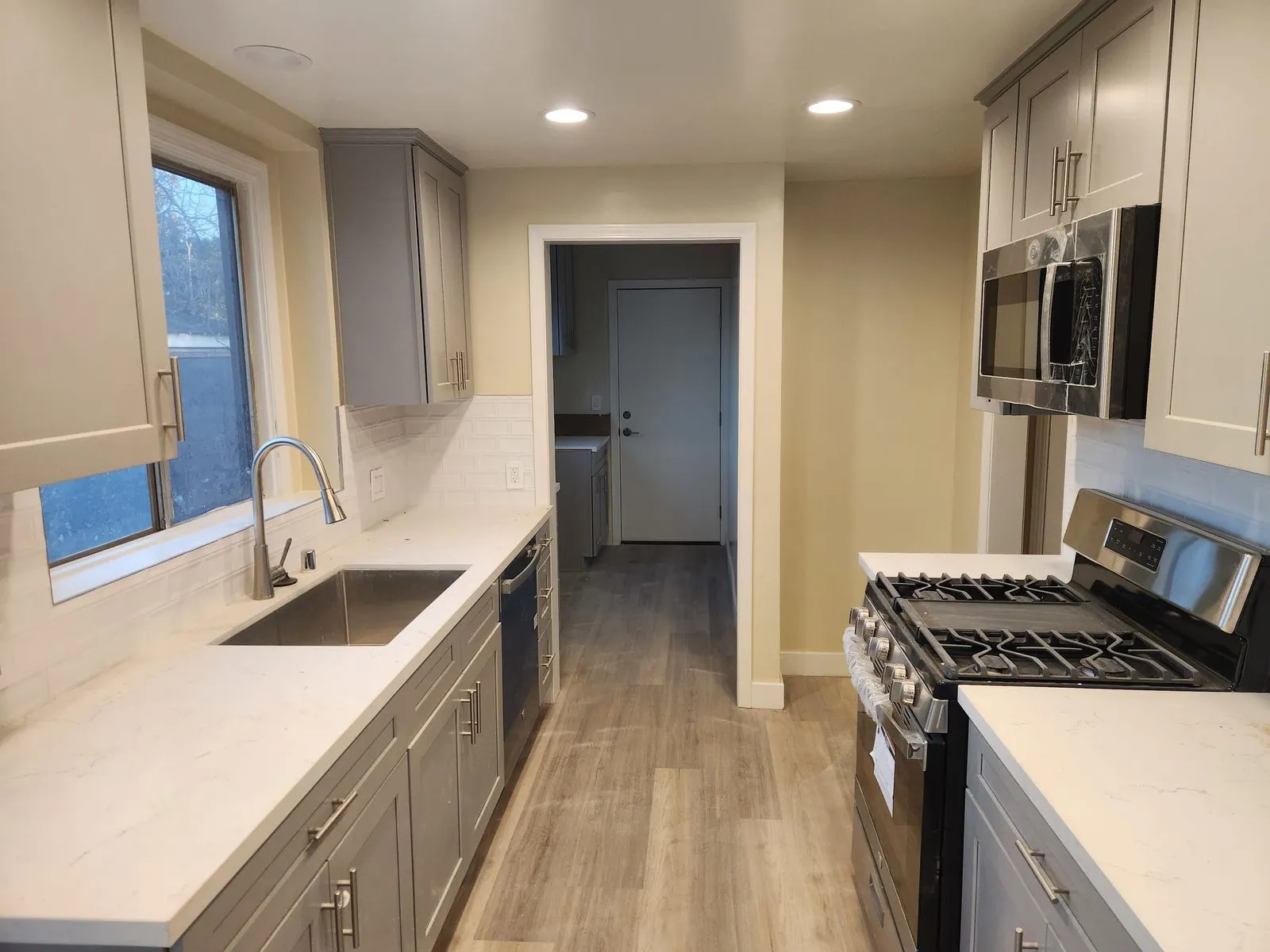 Remodeled galley kitchen with stainless steel appliances